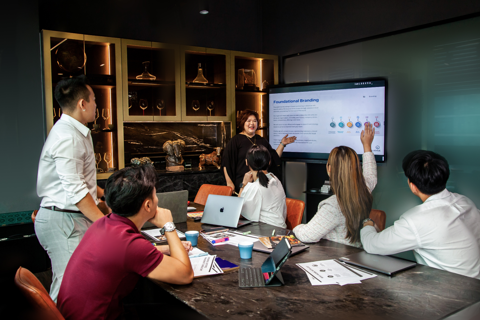 Singapore SME owner reviewing business challenges with Bluehive consultants